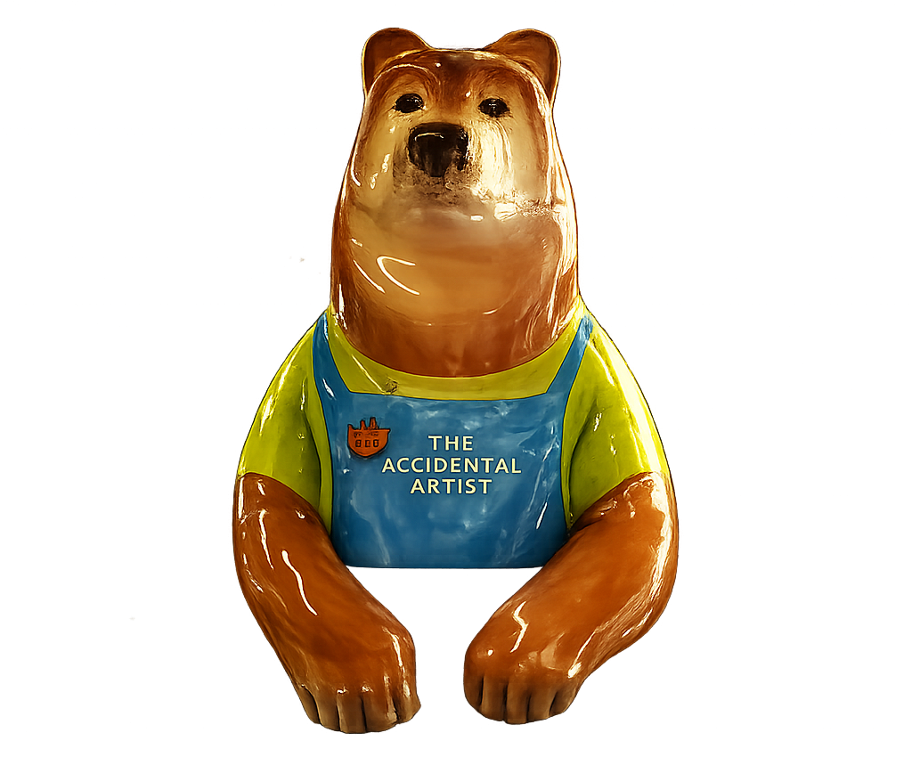 Bear statue wearing a colorful shirt with text 'The Accidental Artist'.
